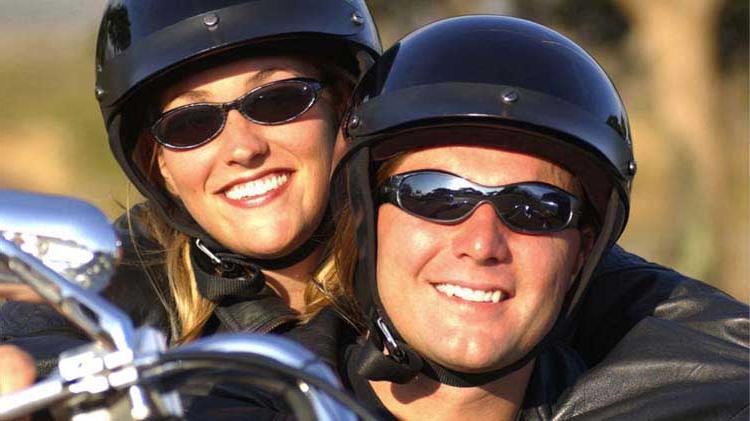 Couple safely riding double on a motorcycle.